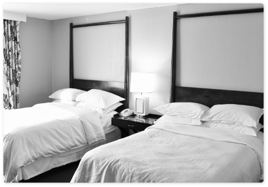 two-beds-with-white-linen-pillows-hotel-motel-room-bedroom-with-lamp-nobody